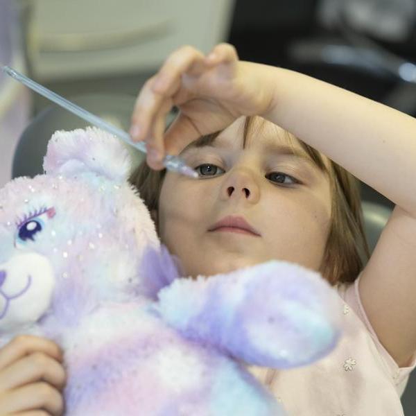 Child holding the Wand Local anaesthetic